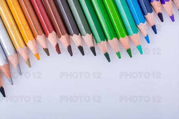 Color Pencils of Various colors placed on white background