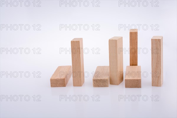 Wooden domino pieces positioned on white background