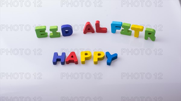 The word EID EL FITR written with colorful letter blocks