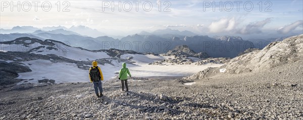 View of rocky plateau with glacier and remnants of snow