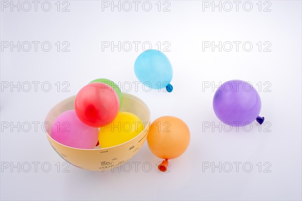 Colorful small baloons in a globe on a white background