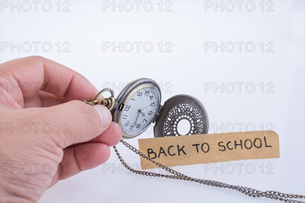 Back to school written title and a pocket watch