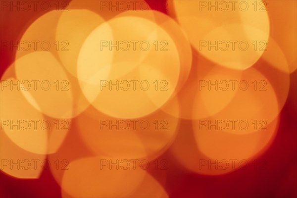 Red tone blurs the bokeh light. Defocused Red and orange holiday bokeh. Abstract christmas background