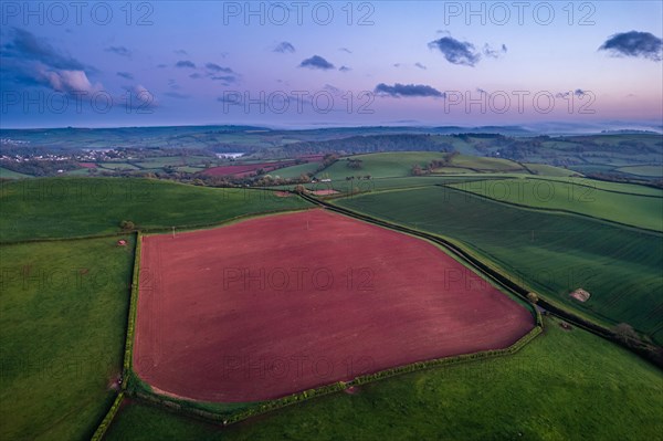 Sunset over fields and farms from a drone