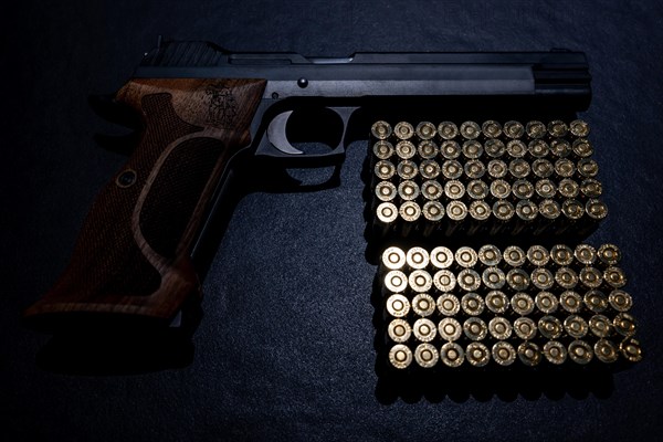 Elegant Semiautomatic 9mm Handgun with Swiss Wilhelm Tell Symbol Leaning with Bullet Ammunition in Switzerland