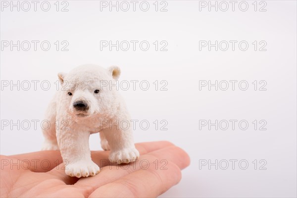 Hand holding a Polar bear model