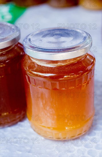 Glass jar of full of fresh honey with lid