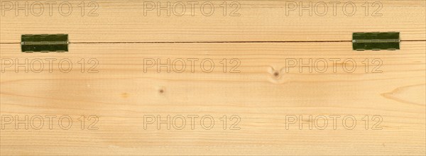 Light brown wood texture background with metal hinges