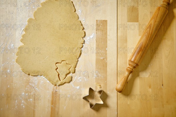 Top view of kitchen table with rolled out cookie dough