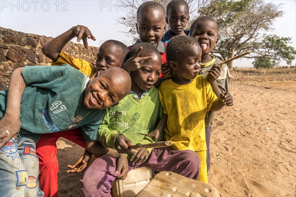 A group of African children with self-made drums singing and playing