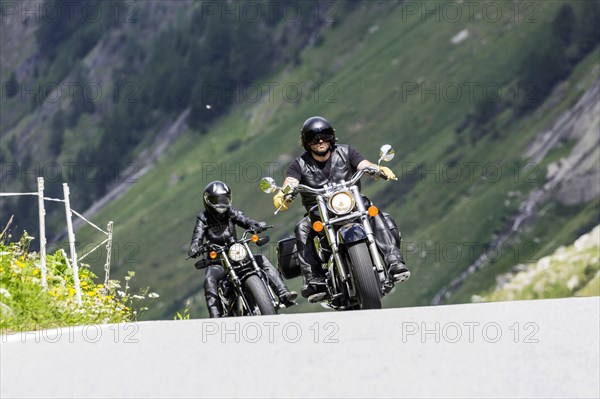 Motorbike on the winding Nufenen Pass in the Alps