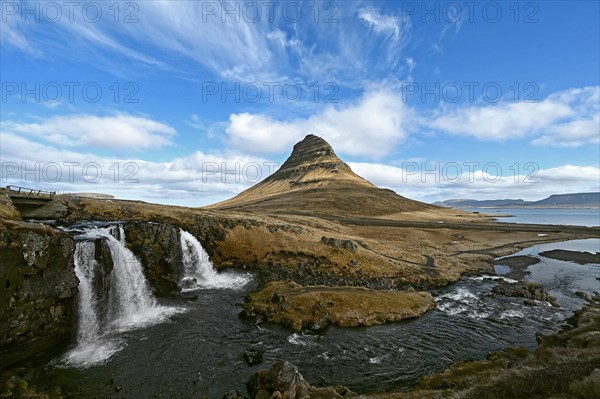 Kirkjufellsfoss waterfall and Kirkjufell mountain on the north coast of the Snaefellsnes peninsula in western Iceland