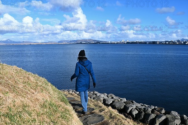 Tourist on the outdoor installation Pufa by artist Olof Norda in the old harbour