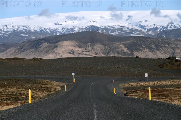 Road to the small peninsula of Dyrholaey on the south coast with a view of the glacier Myrdalsjoekull