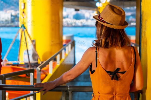 Tenerife ferry heading to Hierro or La Gomera from Los Cristianos. Unrecognizable woman leaving the port