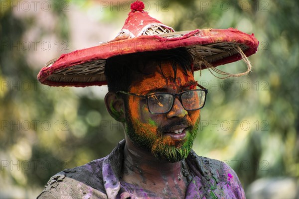 Reveller smear with 'Gulal' or coloured powder to celebrate Holi