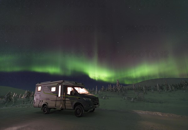 With motorhome in Pallas Yllaestunturi National Parkk in winter under the northern lights