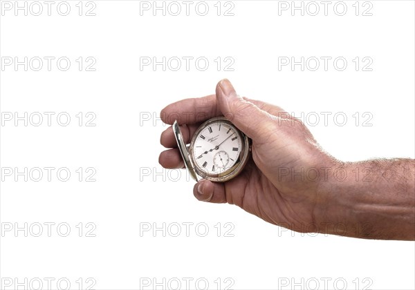 A senior man holding a silver pocket watch