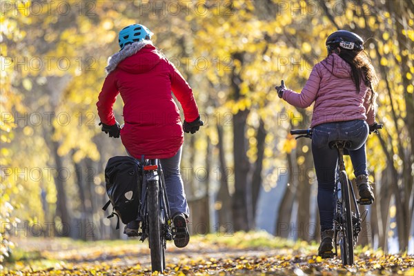 Two woman riding bicycles