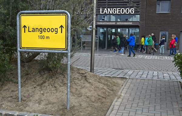 Place-name sign with the inscription Langeoog 100 m in front of the ferry house in Bensersiel