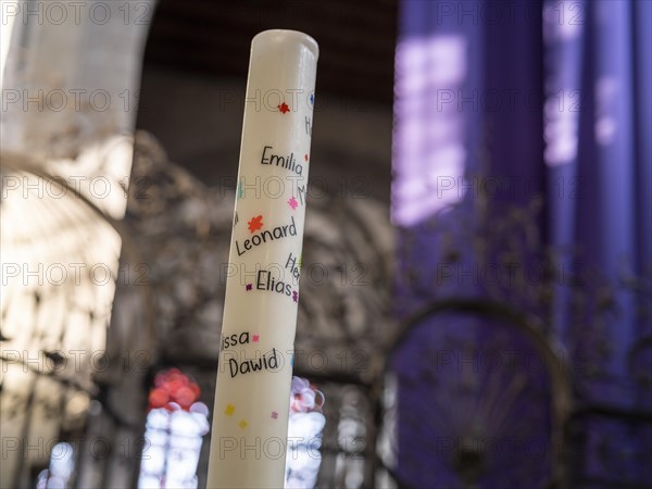 Candle with the names of the First Communion children in the chancel of the Minster of St. Mary and St. Mark