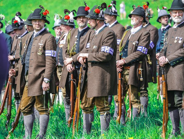 Mountain riflemen gather at the patron saint's day in a meadow near Gmund am Tegernsee