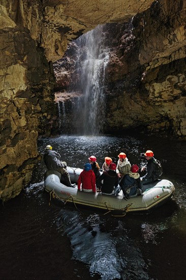 Visitors ride in rubber dinghy