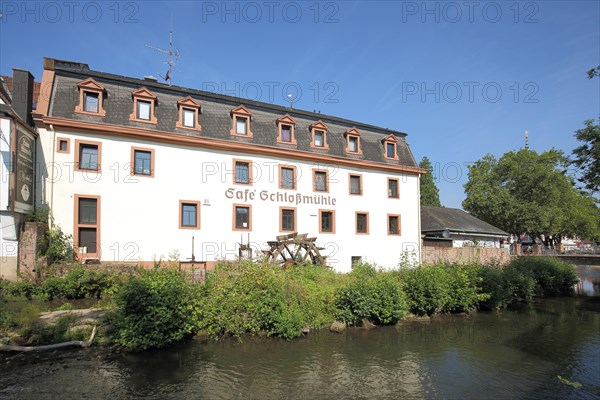 Cafe Schlossmuehle with mill wheel and brook Muemling