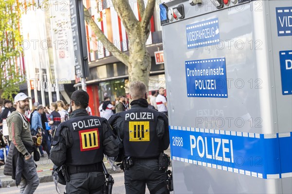 Police officers next to a vehicle labelled video vehicle