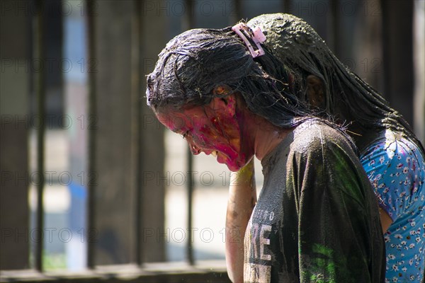 Reveller smear with 'Gulal' or coloured powder to celebrate Holi