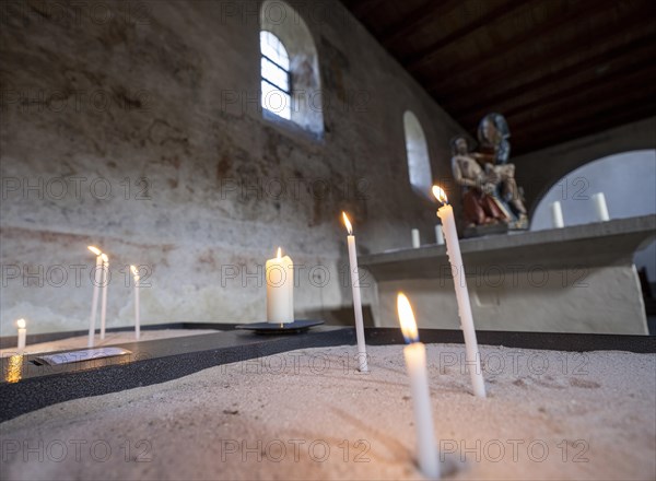 Candles in front of a Pieta in the side aisle of the Minster of St. Mary and St. Mark