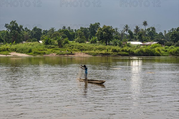 Fisherman in his dugout canoe