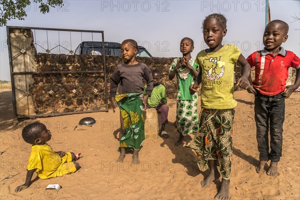 A group of African children singing and playing