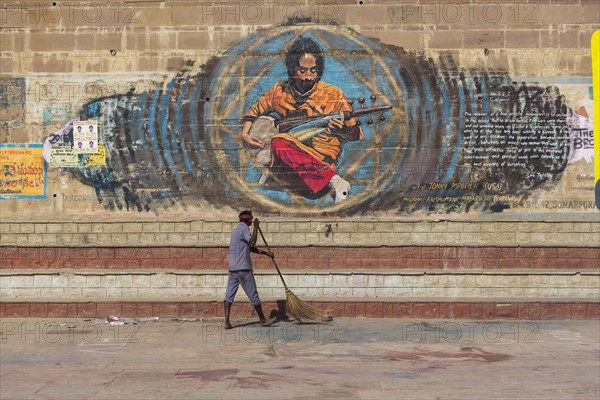 Street sweeper on the steps at the holy river Ganges