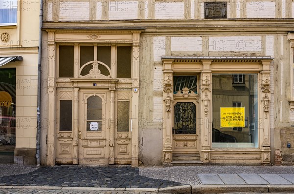 Front gate and shop window of the heritage-protected building Poelkenstrasse 11 in the historic Neustadt that is available for rent at the time of the photograph