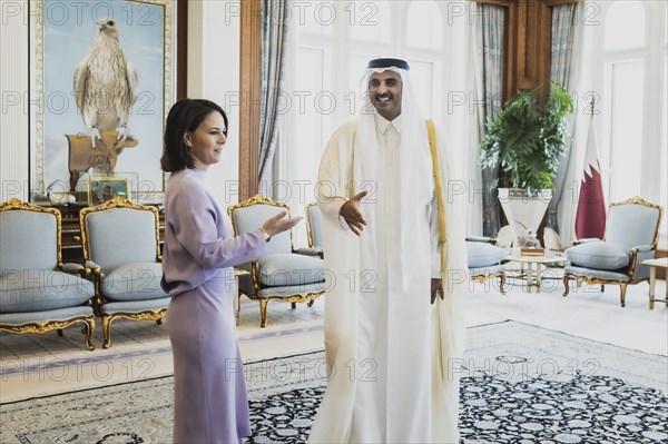 (L-R) Annalena Baerbock (Buendnis 90 Die Gruenen), Federal Minister for Foreign Affairs, and Sheikh Tamim bin Hamad bin Khalifa Al Thani, Emir of the State of Qatar, photographed during a joint meeting in Doha, 17 May 2023. Baerbock is travelling to Saudi Arabia and Qatar on her three-day trip., Doha, Qatar, Asia