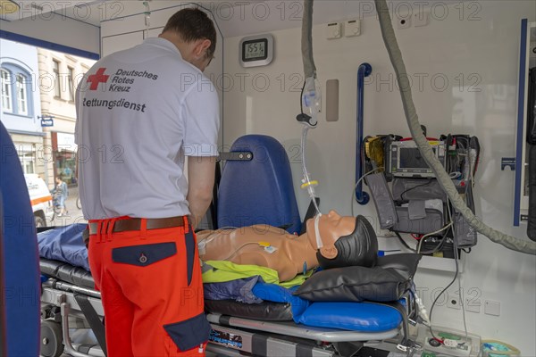 DRK staff in the ambulance Ambulance with dummy as demonstration