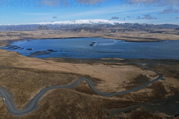 Road to the small peninsula of Dyrholaey on the south coast with a view of the glacier Myrdalsjoekull