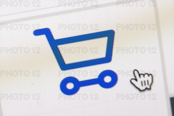 Symbol photo on the subject of online shopping. The symbol of a shopping cart and a mouse pointer can be seen on the display of a computer. Berlin