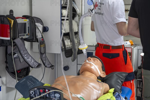 DRK staff in the ambulance Ambulance with dummy as demonstration