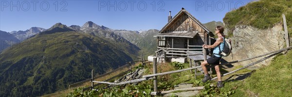 Woman in front of Rainkarhuette in the Radstaetter Tauern