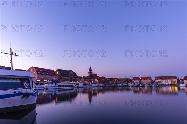 Town harbour of the small town of Waren in the evening light