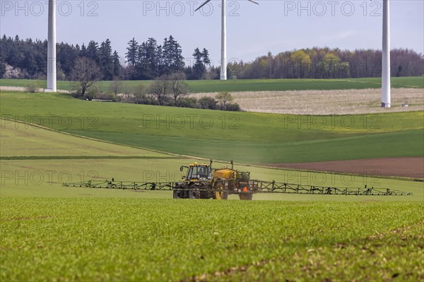 Farmer with tractor working his field in spring
