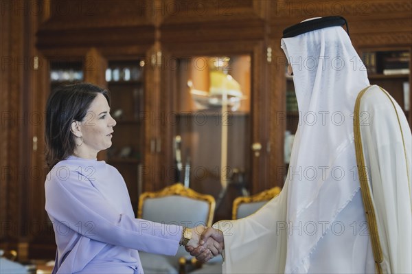 (L-R) Annalena Baerbock (Buendnis 90 Die Gruenen), Federal Minister for Foreign Affairs, and Sheikh Tamim bin Hamad bin Khalifa Al Thani, Emir of the State of Qatar, photographed during a joint meeting in Doha, 17 May 2023. Baerbock is travelling to Saudi Arabia and Qatar on her three-day trip., Doha, Qatar, Asia