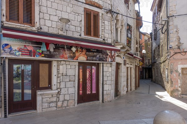 Advertising posters on old stone houses in the coastal town of Umag