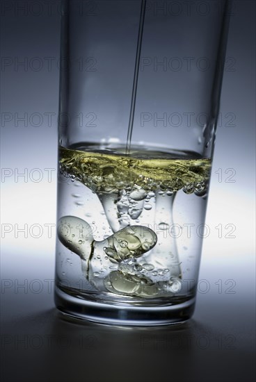 Oil poured in glass of water