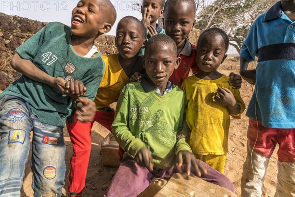 A group of African children with self-made drums singing and playing