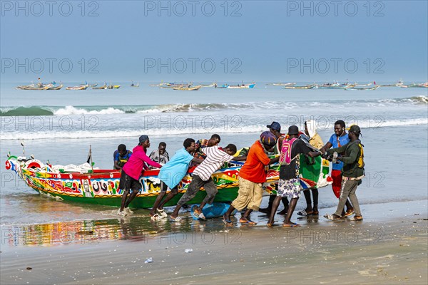 Men pulling Colourful fishing boat