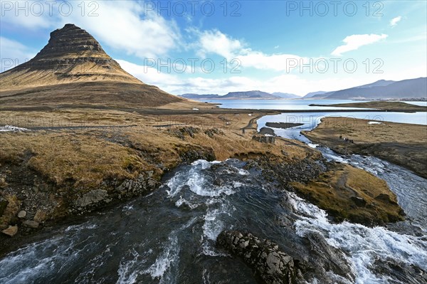 Kirkjufellsfoss waterfall and Kirkjufell mountain on the north coast of the Snaefellsnes peninsula in western Iceland