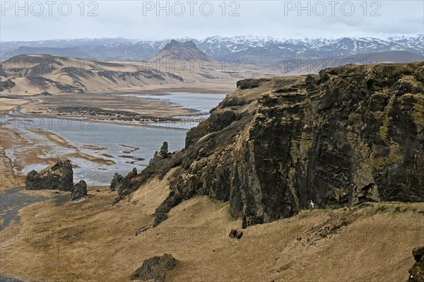 Small peninsula Dyrholaey on the south coast with view of the glacier Myrdalsjoekull